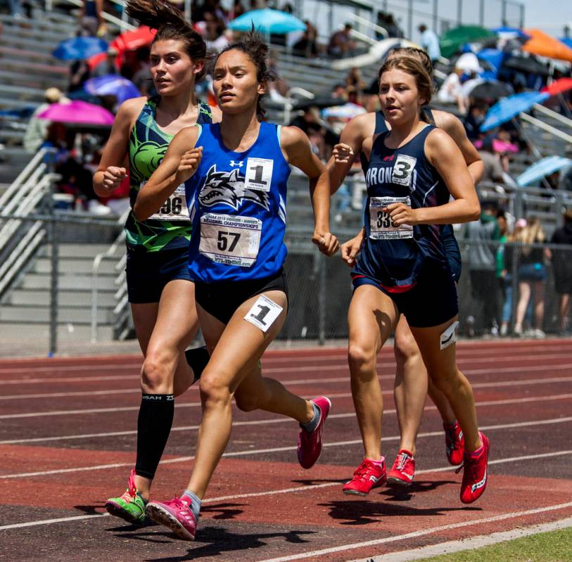 Basic junior Raquel Chavez, center, runs in the 1,600-meter run, finishing first with a time ...