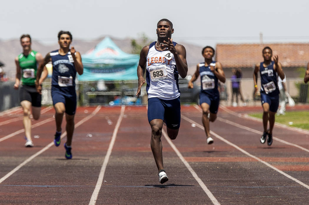 Legacy senior sprinter Jeriel Thomas, center, runs in the 400-meter sprint, winning his heat ...