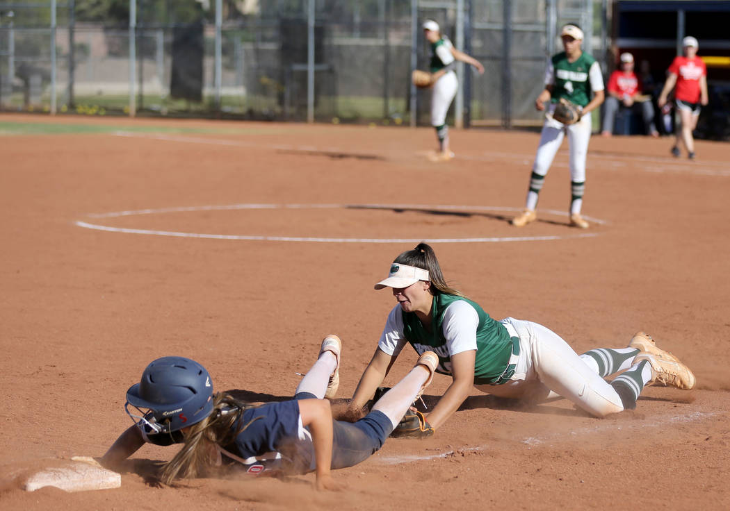 Coronado baserunner Tatum Spangler (5) dives safely back to third past the tag of Green Vall ...