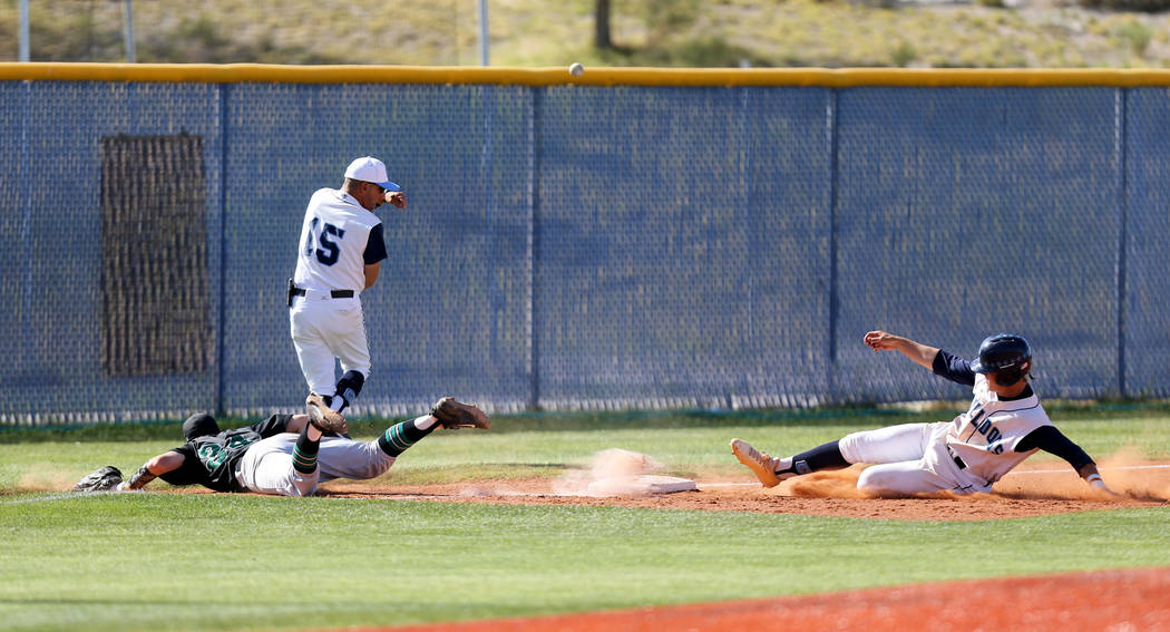 Palo Verde infielder Palo Verde E.J. Arnold (34) dives for a wild throw as Centennial baseru ...