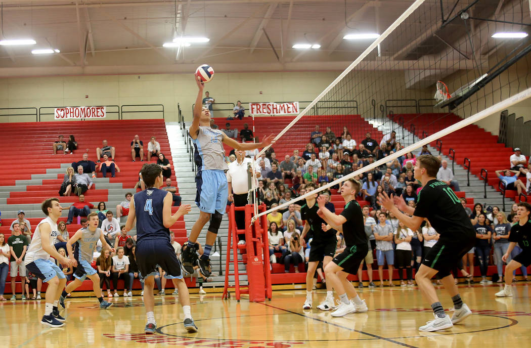 Centennial High School’s Teon Taylor (13) spikes the ball in the Sunset Region boys se ...