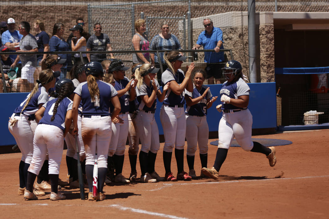 Shadow Ridge teammates greet Alyssa Stanley (22) at the plate after a home run during the 20 ...