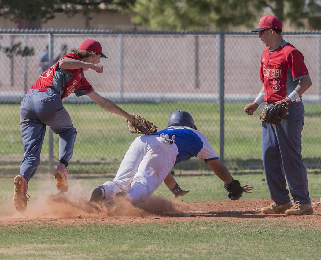 Desert Pines senior Juan Castaneda (7) is tagged out by Southeast Career Tech senior pitcher ...
