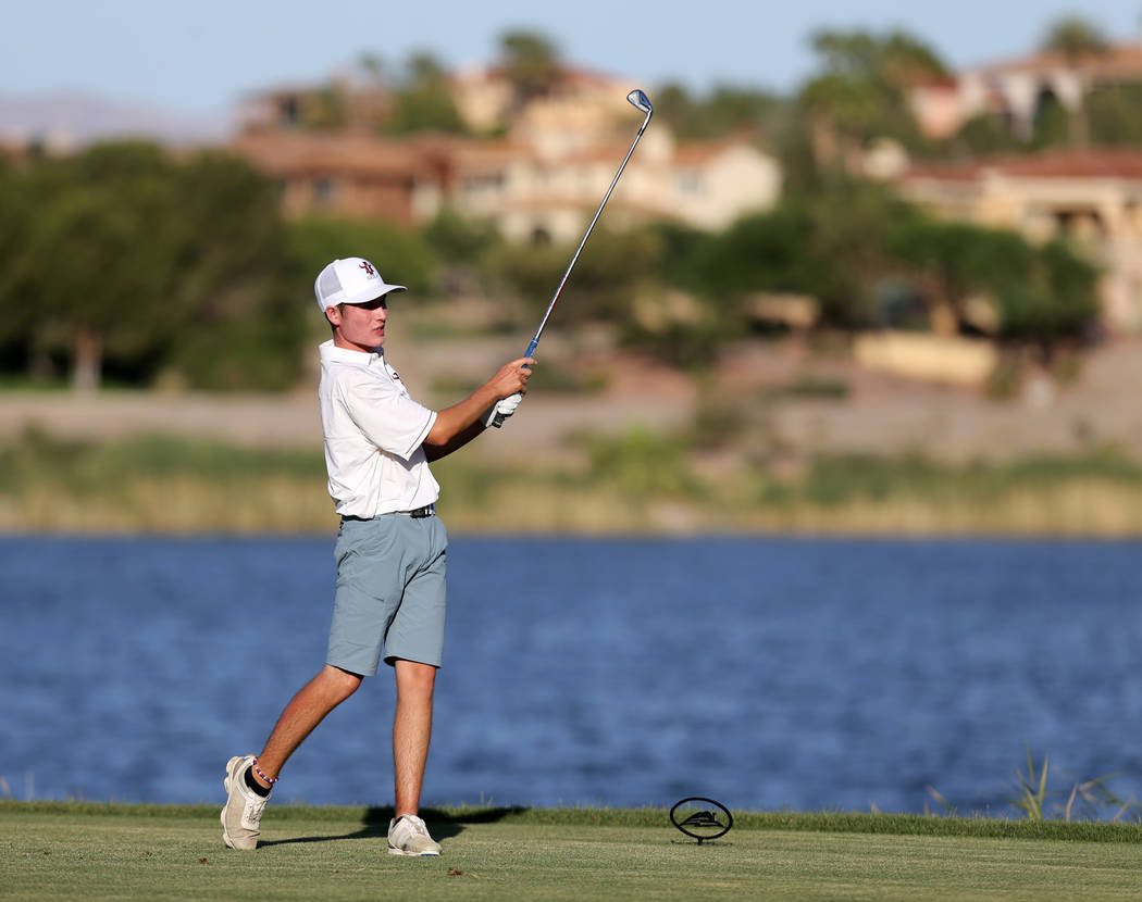Arbor View’s Cameron Gambini watches his tee shot on 18th hole at Reflection Bay Golf ...