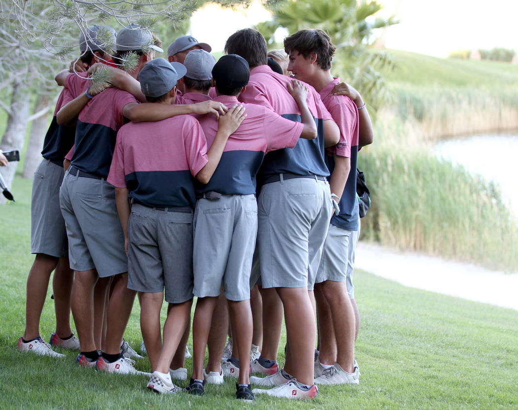 Members of the Coronado High School golf team huddle after winning the team Class 4A Nevada ...