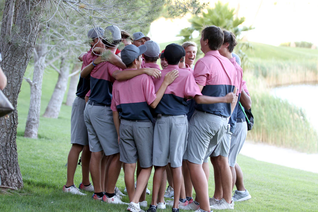 Members of the Coronado High School golf team huddle after winning the team Class 4A Nevada ...