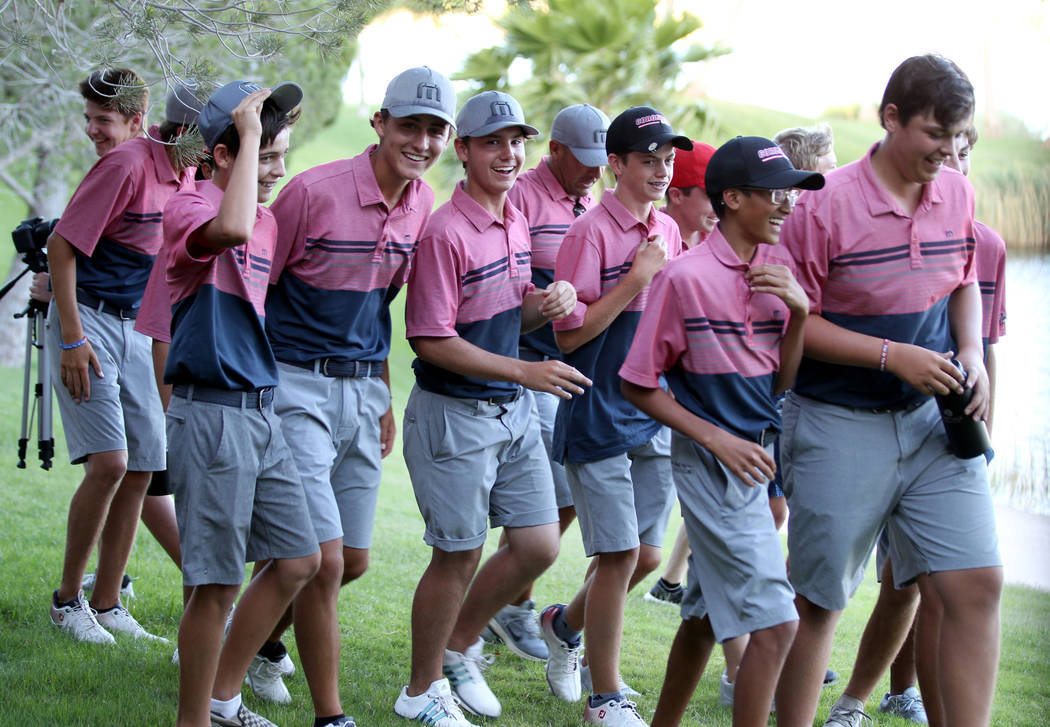 Members of the Coronado High School golf team react after winning the team Class 4A Nevada s ...