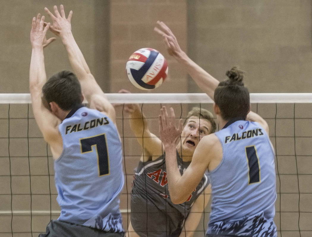 Arbor View senior Jake Reid (3) makes a kill past Foothill’s Dylan Meuller (1) and Cad ...