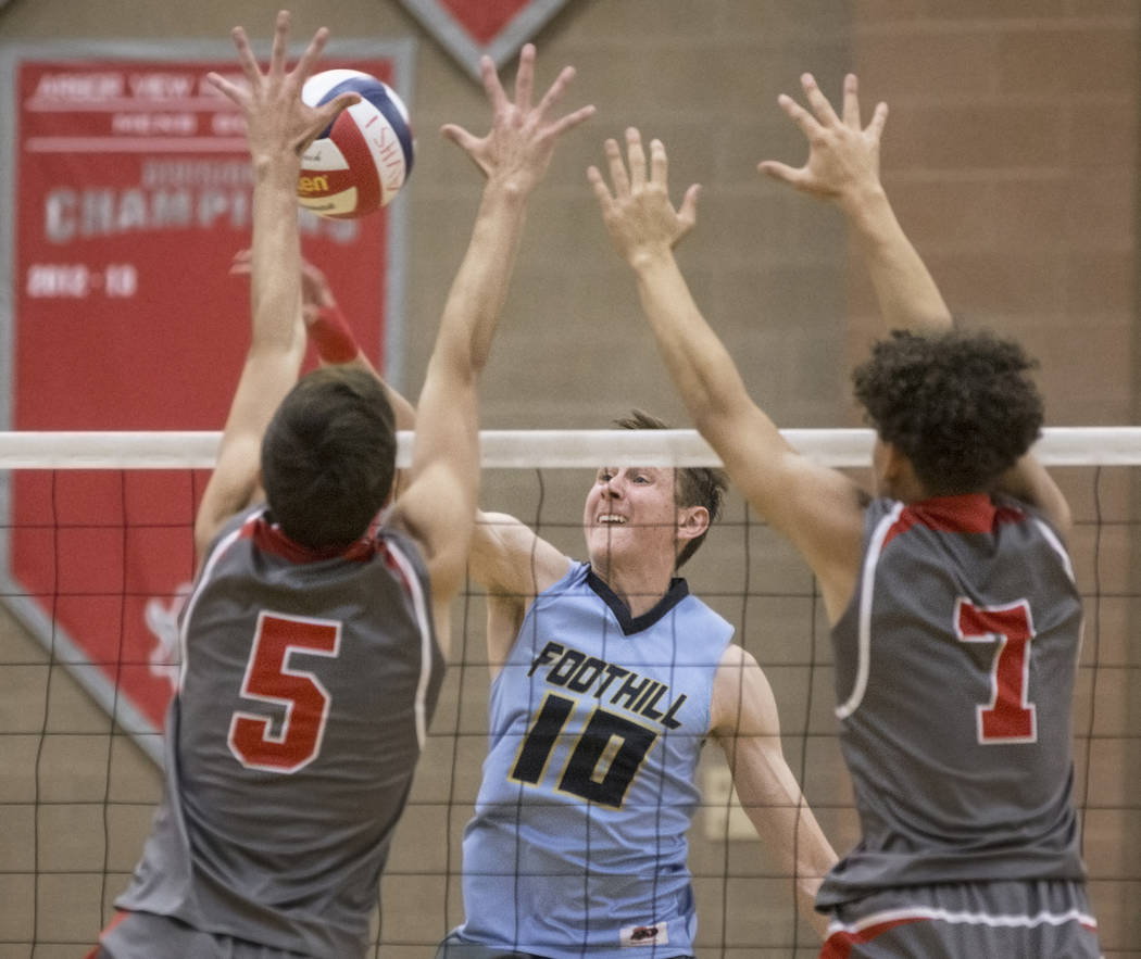 Foothill junior Caleb Stearman (10) makes a kill past Arbor View’s Gideon Belnap (5) a ...