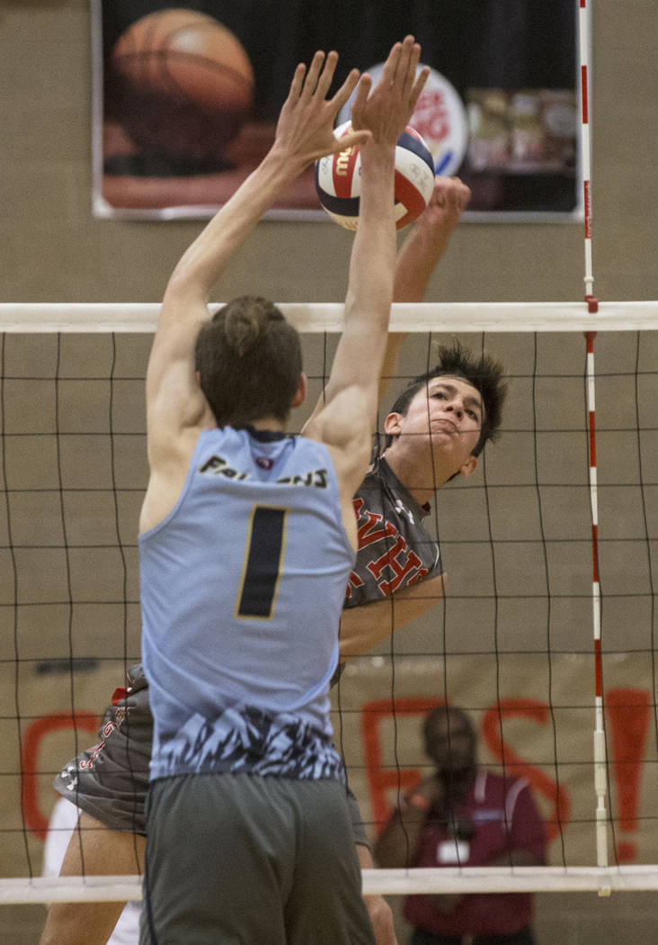 Arbor View junior Gideon Belnap (5) makes a kill past Foothill senior Dylan Meuller (1) duri ...