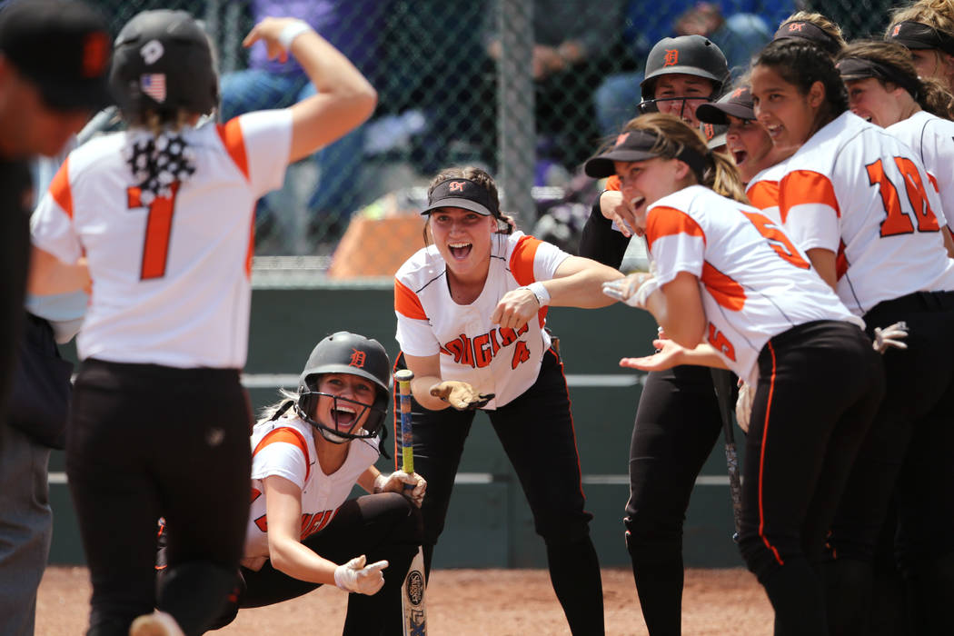 The Douglas Tigers greet Chloe Pratt at the plate after her home run against the Basic Wolve ...