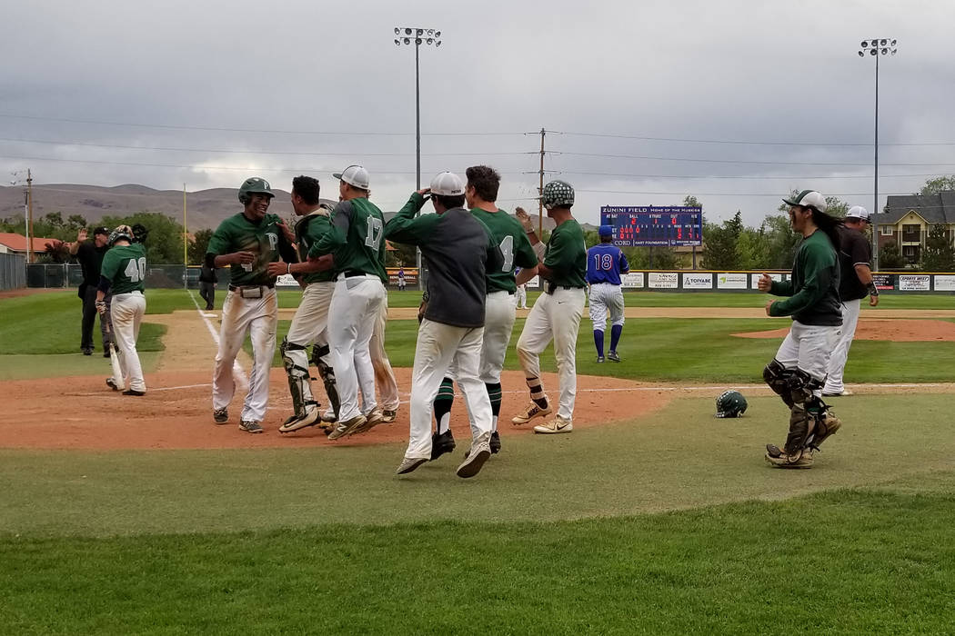 Palo Verde players congratulate Karsonne Winters after he scored a run against Reno in the f ...