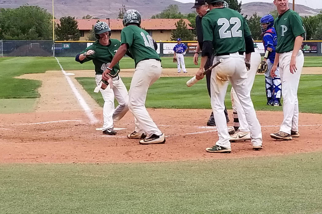 Palo Verde players congratulate Nate Bartlett after his fifth-inning home run against Reno i ...