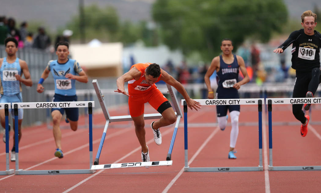 Bishop Gorman’s Jake Phillips crashes in the final stretch of the 4A 300 hurdles at t ...
