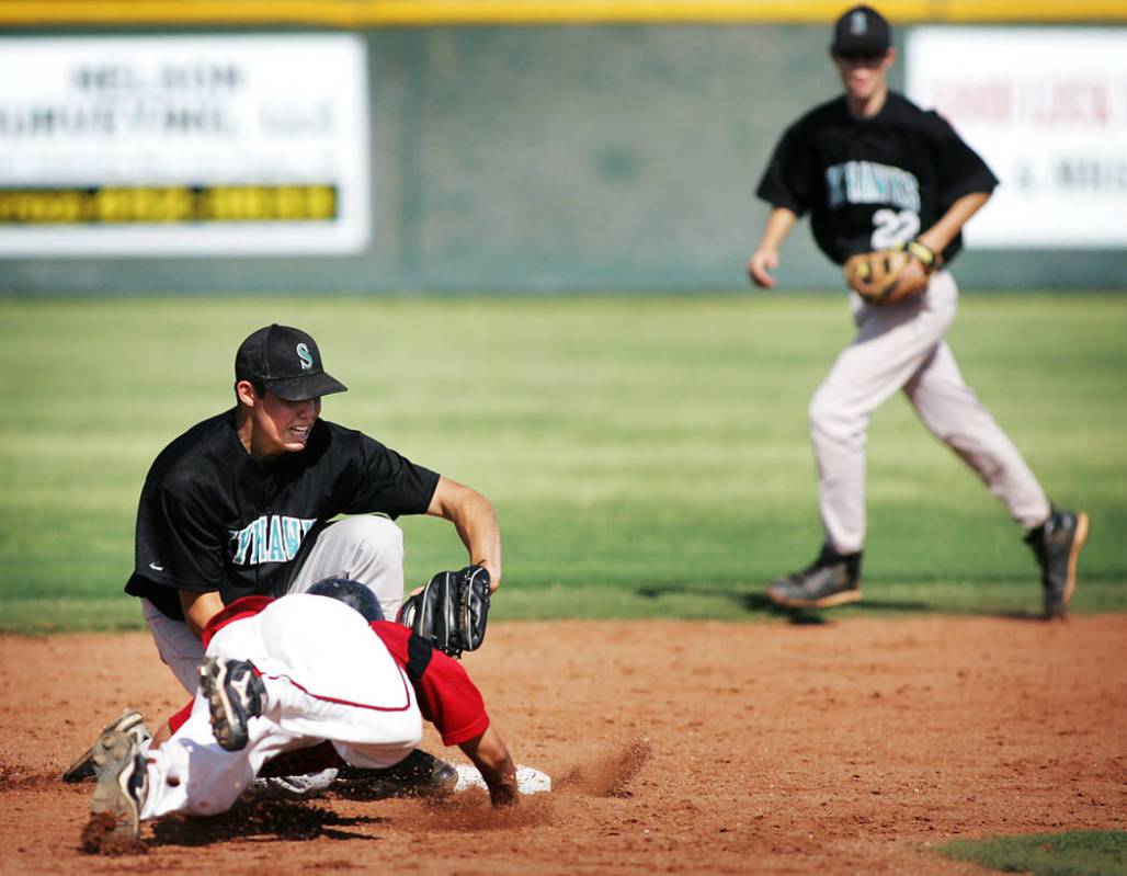Las Vegas High School baseball player Timothy Daniel gets picked off by Silverado shortstop ...