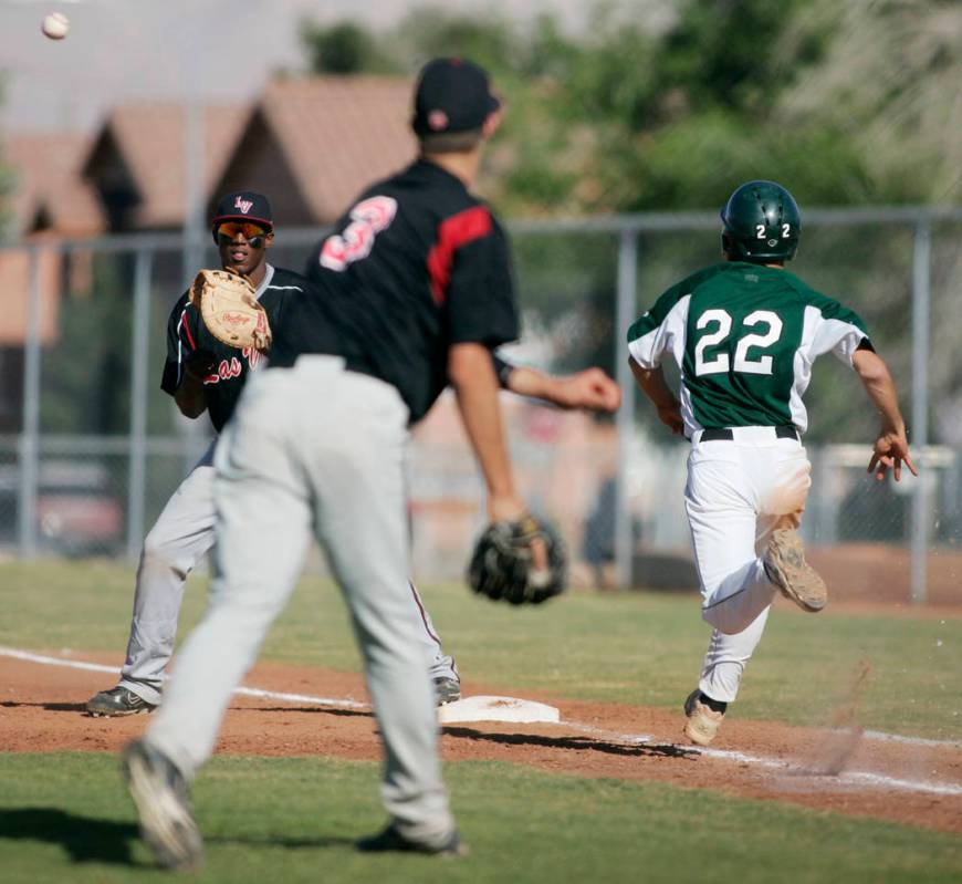 Las Vegas High School baseball player Bryan Harper throws to first baseman Marvin Campbell f ...