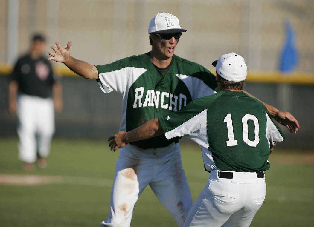 Rancho relief pitcher Zak Qualls celebrates with teammate P.J. Matha, #10, after getting a s ...