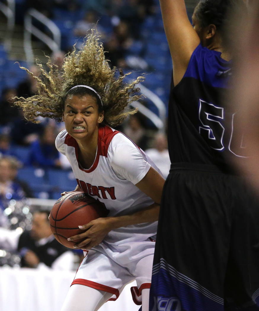 Liberty’s Rae Burrell looks to shoot against McQueen during the NIAA state basketball ...