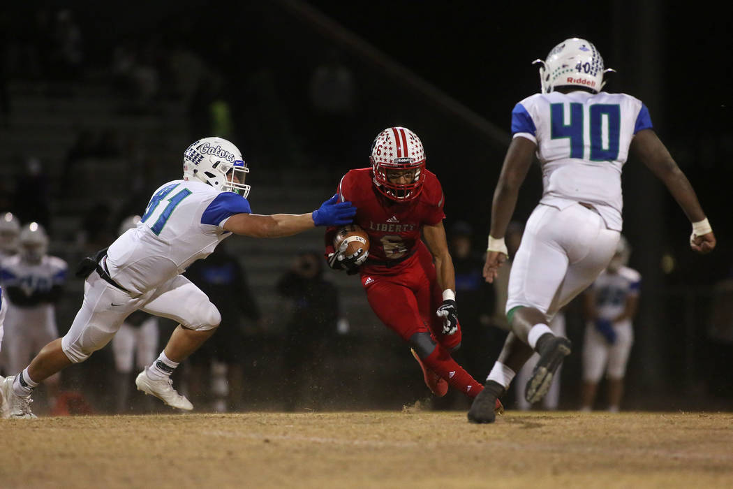 Liberty player Cervontes White (6) runs the ball during the class 4A Sunrise Region title ga ...