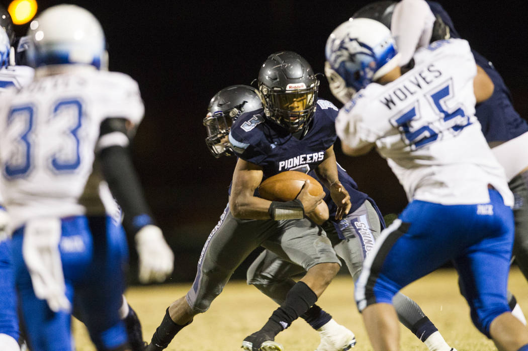 Canyon Spring’s Jayvion Pugh (3) runs the ball against Basic during their playoff foot ...