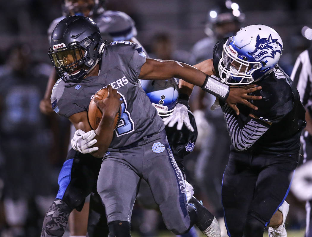 Canyon Springs’ Jayvion Pugh (3) is tackled by Basic during the second quarter of a fo ...