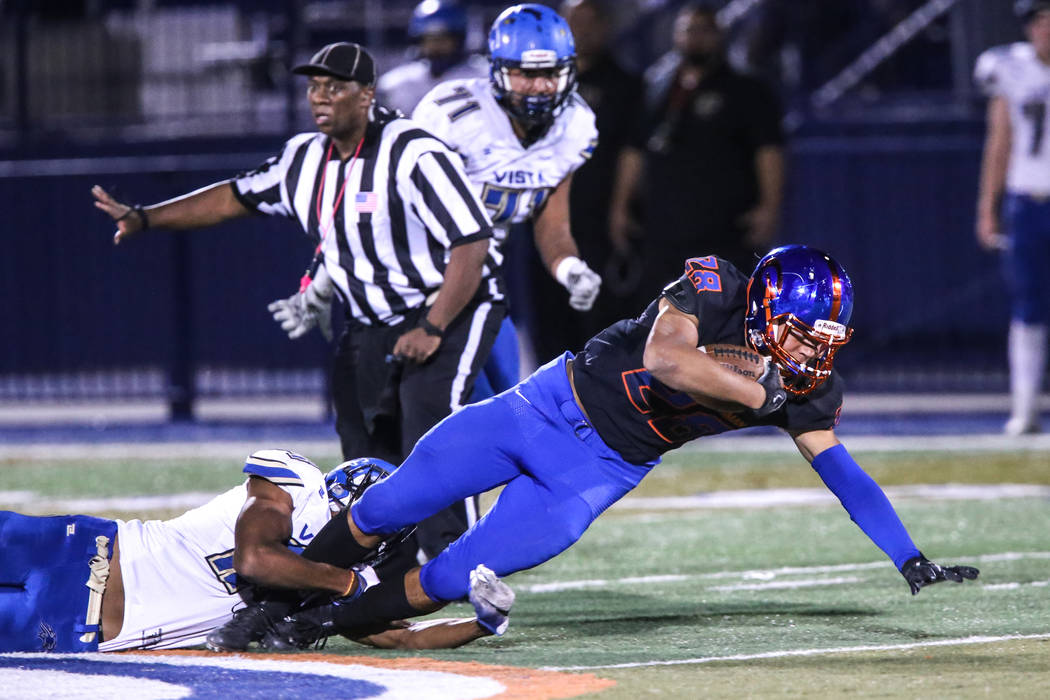 Bishop Gorman’s Amod Cianelli (28), right, is tackled by Sierra Vista during the third ...