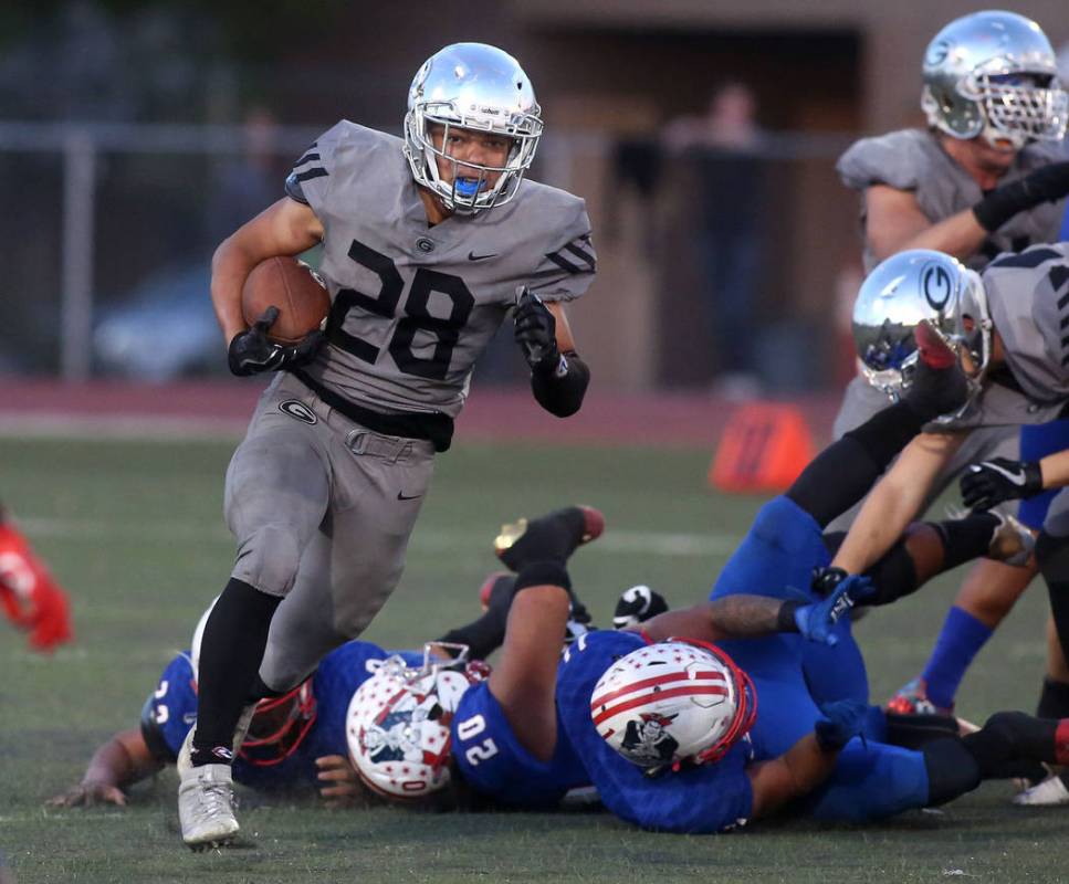 Bishop Gorman player Amod Cianelli (28) runs the ball during the class 4A state semifinal fo ...