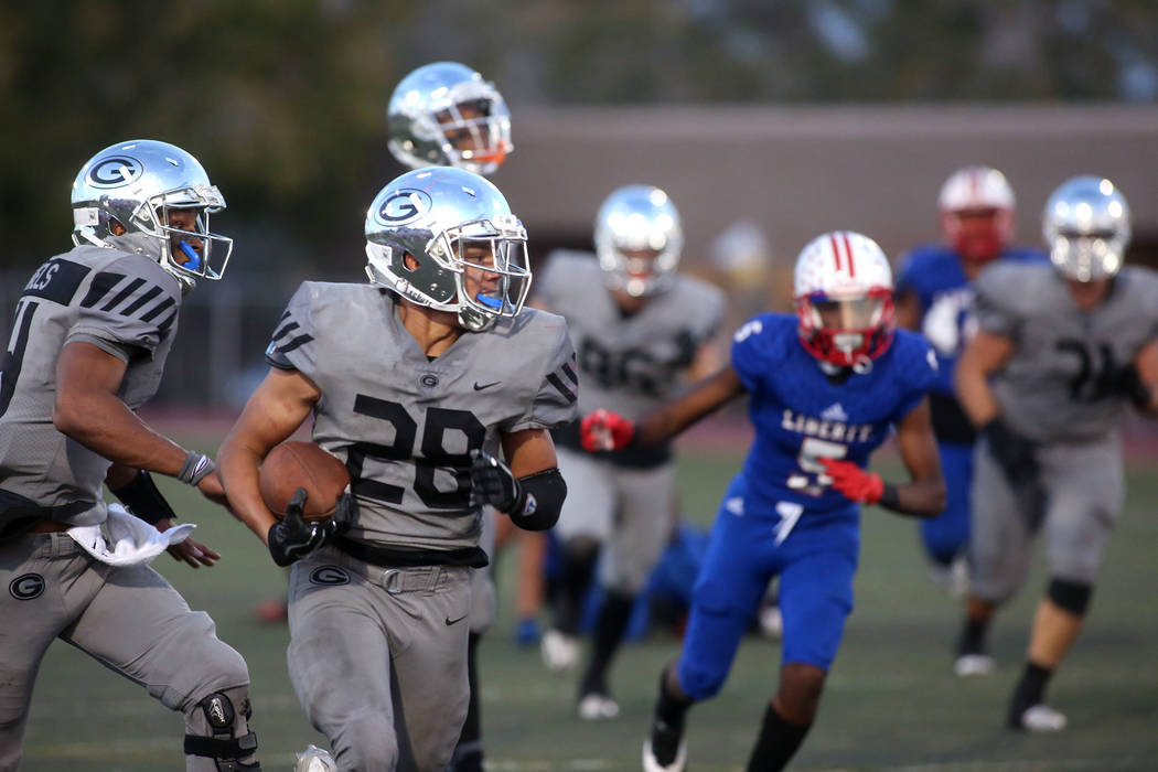 Bishop Gorman player Amod Cianelli (28) runs the ball during the class 4A state semifinal fo ...