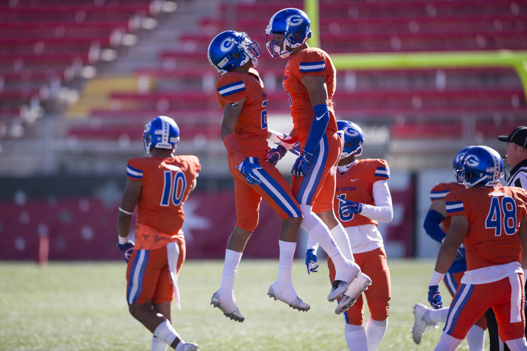 Bishop Gorman Greg Oliver (20), left, celebrates his interception with Damuzhea Bolden in th ...