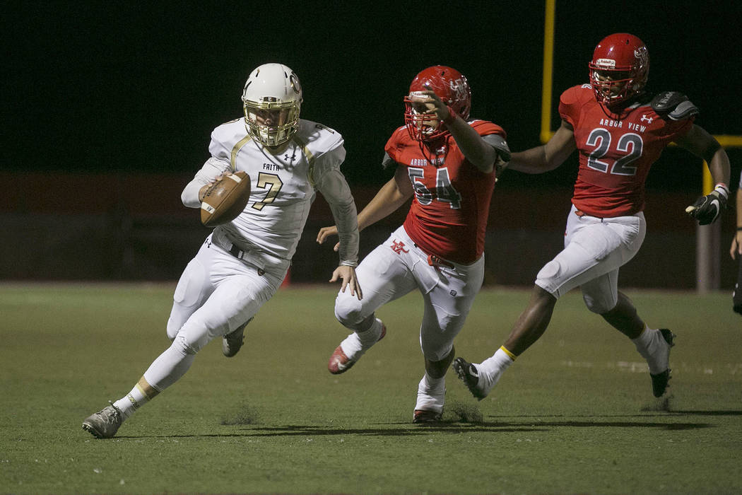 Faith Lutheran quarterback Sagan Gronauer (7) runs the ball with Arbor View players Tai Tuin ...