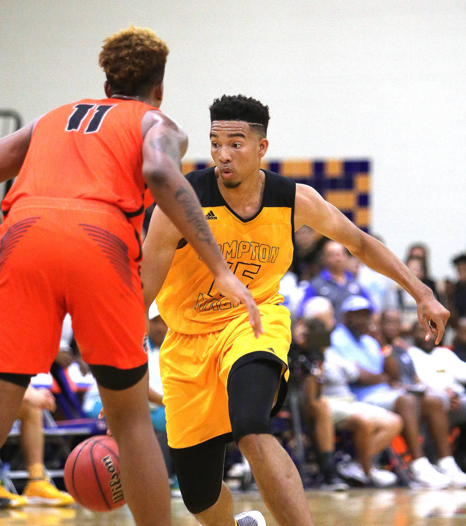 Compton Magic’s Isaiah Mobley (15) attempts to pass Bishop Gorman’s Zaon Collins ...