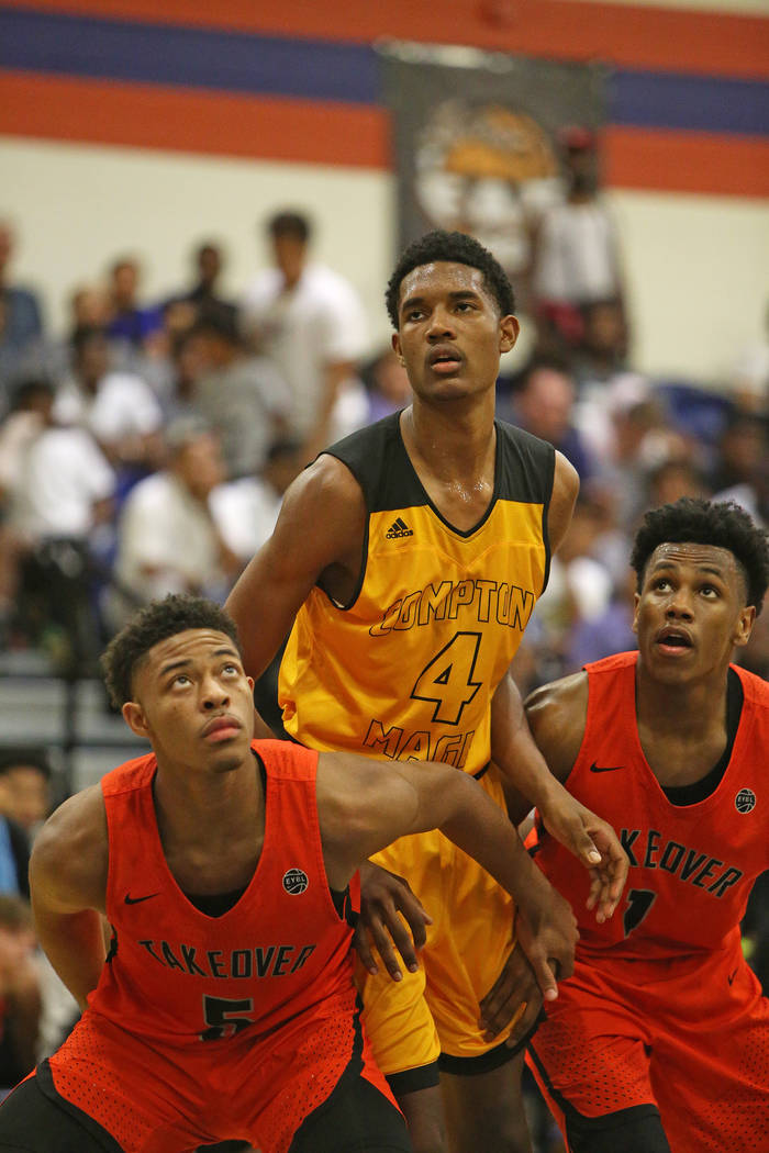 Compton Magic’s Evan Mobley (4) watches a free throw next to Bishop Gorman’s Jam ...