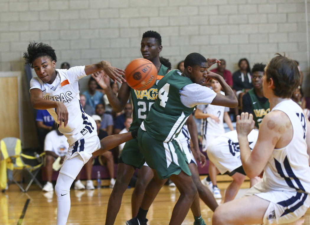 Vegas Elite guard Zaon Collins, left, makes a pass while playing against We All Can Go as pa ...