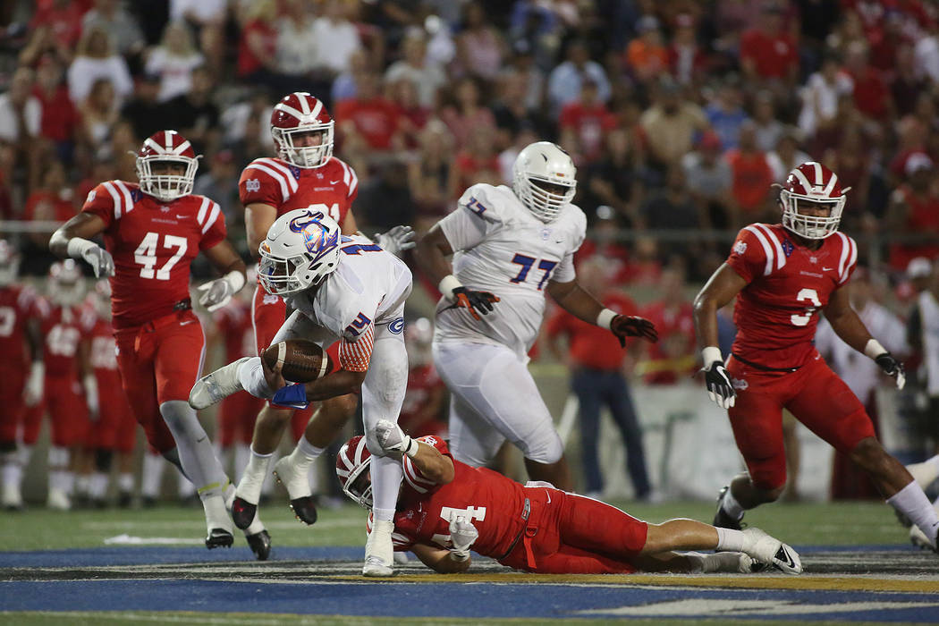 Bishop Gorman player Dorian Thompson-Robinson is tackled by Mater Dei player Brandon LaMarch ...