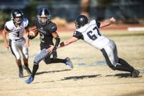 Desert Pines’ Tye Moore (2), center, runs the ball past Spring Creek’s Andrew Ar ...