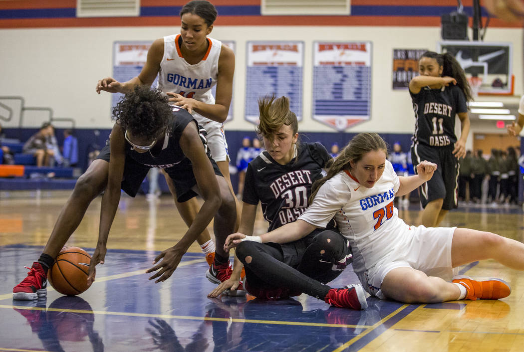 Desert Oasis’ Desi-Rae Young attempts to recover the ball on a rebound against Bishop ...
