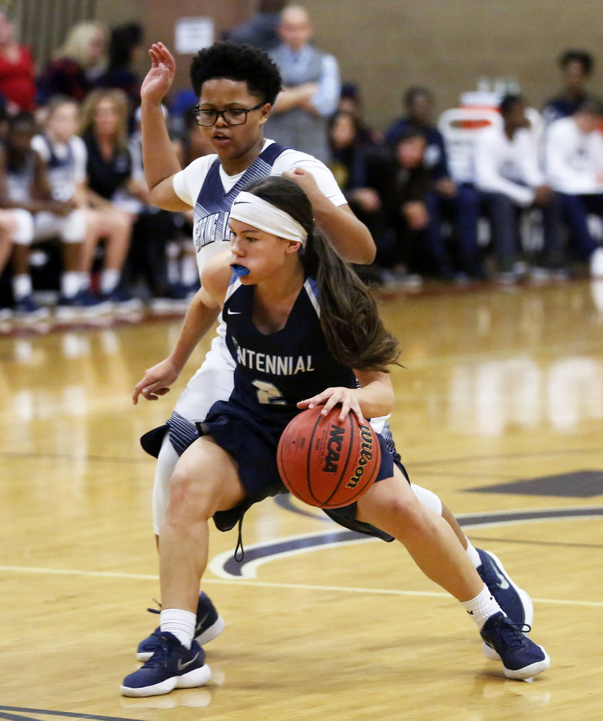 Centennial’s Melanie Isbell (2) defends against Spring Valley’s Deja McDonald (1 ...