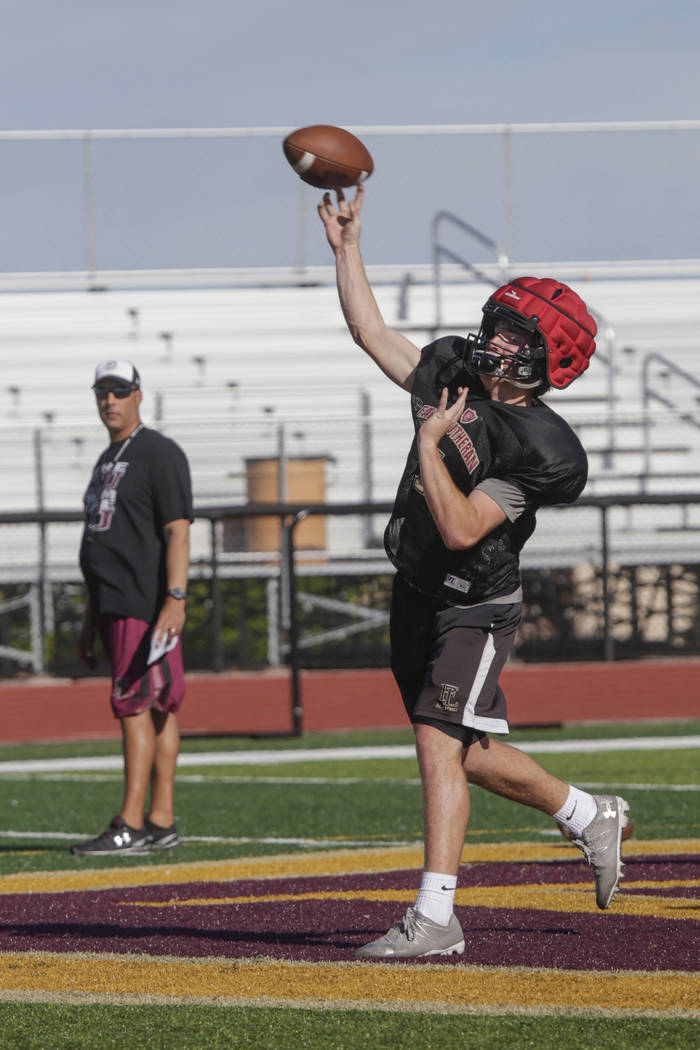 Faith Lutheran quarterback Sagan Gronauer (7) passes to a teammate during practice at Faith ...