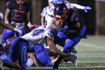 Bishop Gorman’s Ikaika Ragsdale (6), right, runs the ball past Sierra Vista during the ...