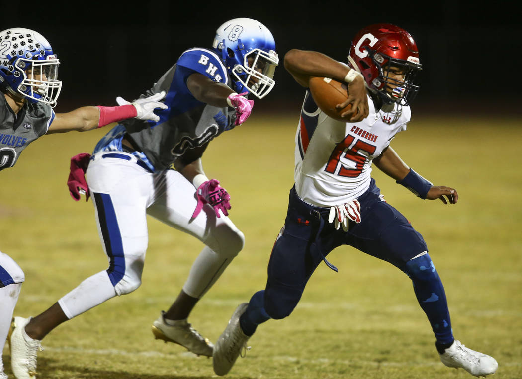 Coronado’s Ayzayah Hartfield (15) runs the ball past Basic’s Leonard Goodwin (8) ...