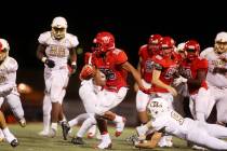 Arbor View player Kyle Graham run the ball as Faith Lutheran attempts to tackle during the ...