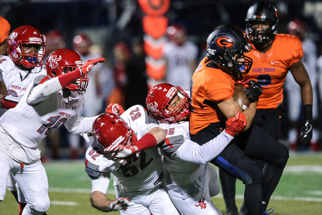 Arbor View’s J.J. Tuinei (35) tackles Bishop Gorman’s Amod Cianelli (28) during ...