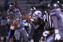 Canyon Springs’ Jayvion Pugh (3) is tackled by Basic during the second quarter of a fo ...