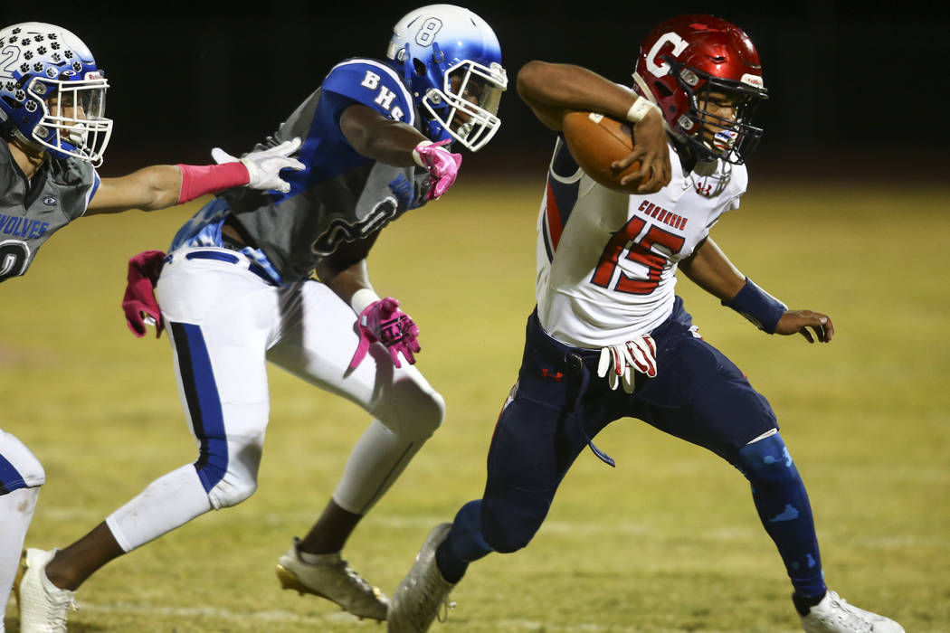Coronado’s Ayzayah Hartfield (15) runs the ball past Basic’s Leonard Goodwin (8) ...