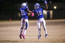 Basic’s Dorian Ivan McAllister (21), left, celebrates with Franco Mays Jr. (10), right ...
