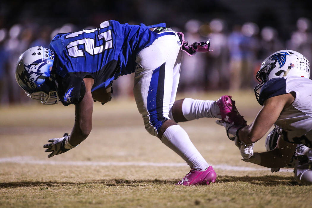 Basic’s Dorian Ivan McAllister (21), left, scores against Foothill during the fourth q ...