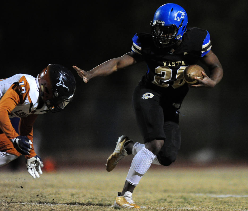 Sierra Vista running back Bryan LaGrange breaks the tackle of Legacy safety Andrew Gamble to ...