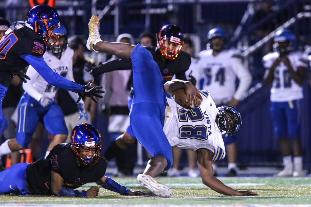 Sierra Vista’s Bryan Lagrange (28), right, falls during a play against Bishop Gorman d ...