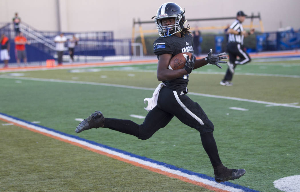 Desert Pines wide receiver Devin McGee (10) looks back after breaking away for a touchdown a ...