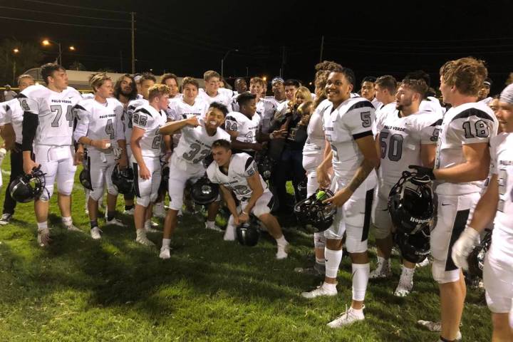 Palo Verde football players pose with the Thursday Night Lights trophy after a 29-6 road vic ...